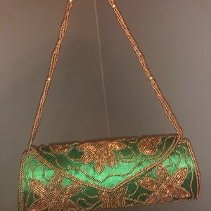 Small emerald green and gold hand bag
